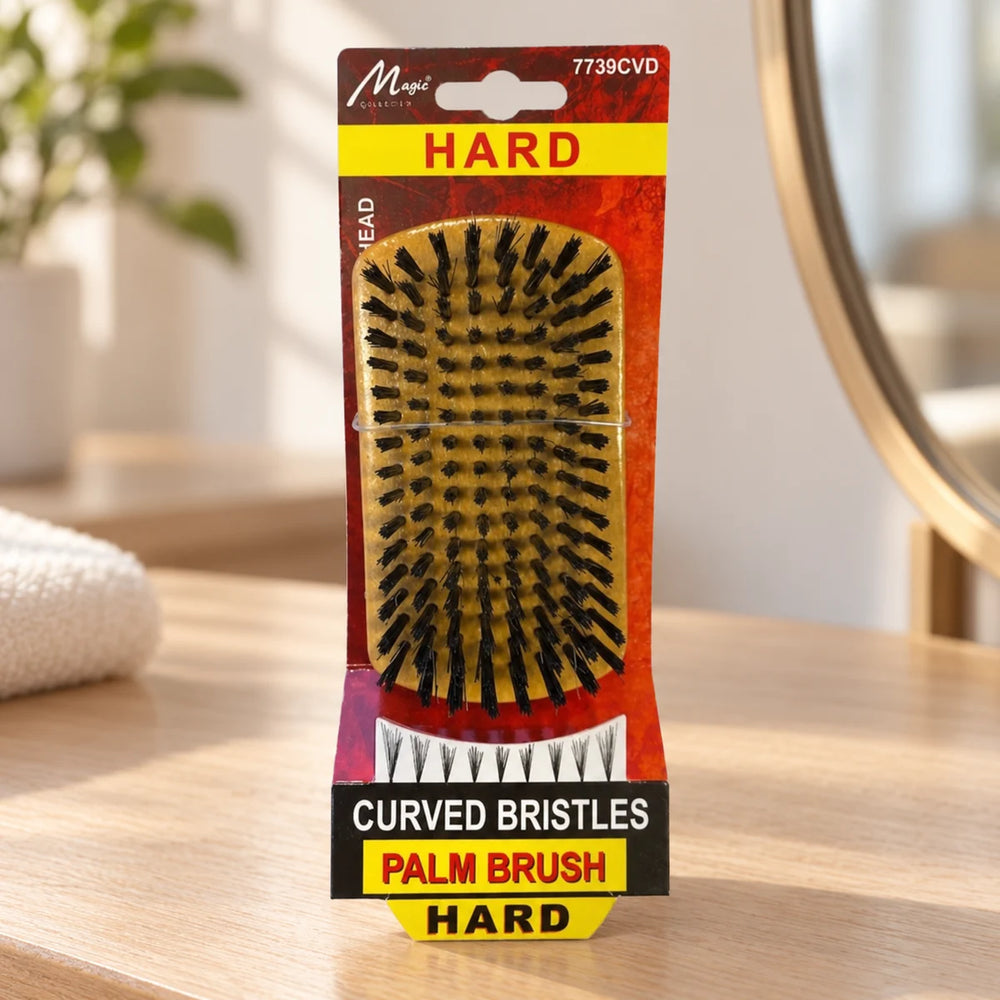 Magic Collection Curved Bristles Hard Palm Brush - Ultimate Wave Definition & Smooth Hair on a bathroom vanity or dressing table.