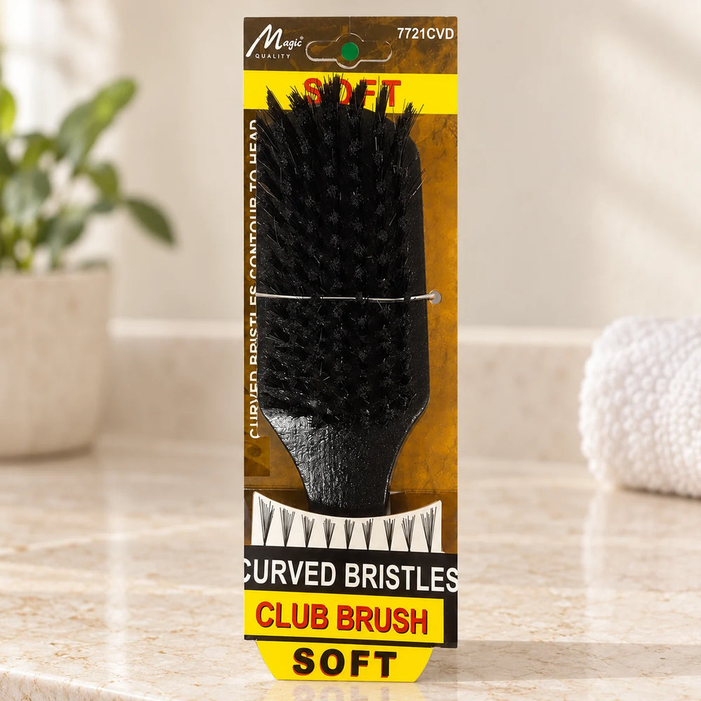 Magic Collection Curved Bristles Soft Club Brush for Defining Waves & Styling Hair on a bathroom vanity or dressing table.