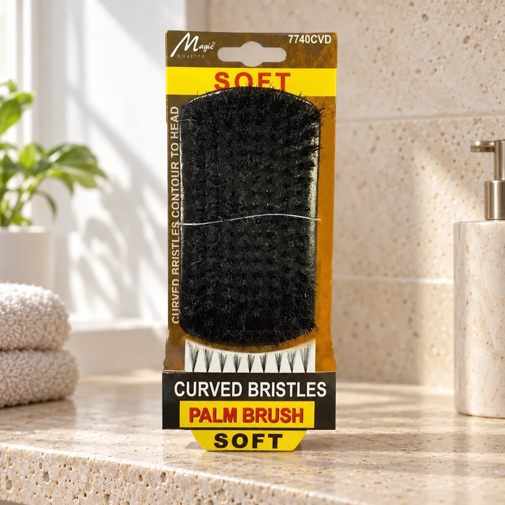 Magic Collection Curved Bristles Soft Palm Brush: Gentle Detangling & Wave Creation for All Hair Textures on a bathroom vanity or dressing table.