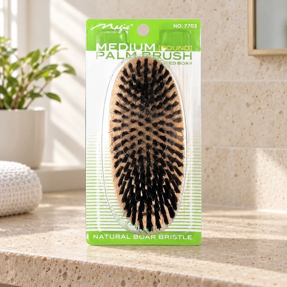 Magic Collection Medium Round Palm Brush for Defined Waves & Smooth Styles on a bathroom vanity or dressing table.
