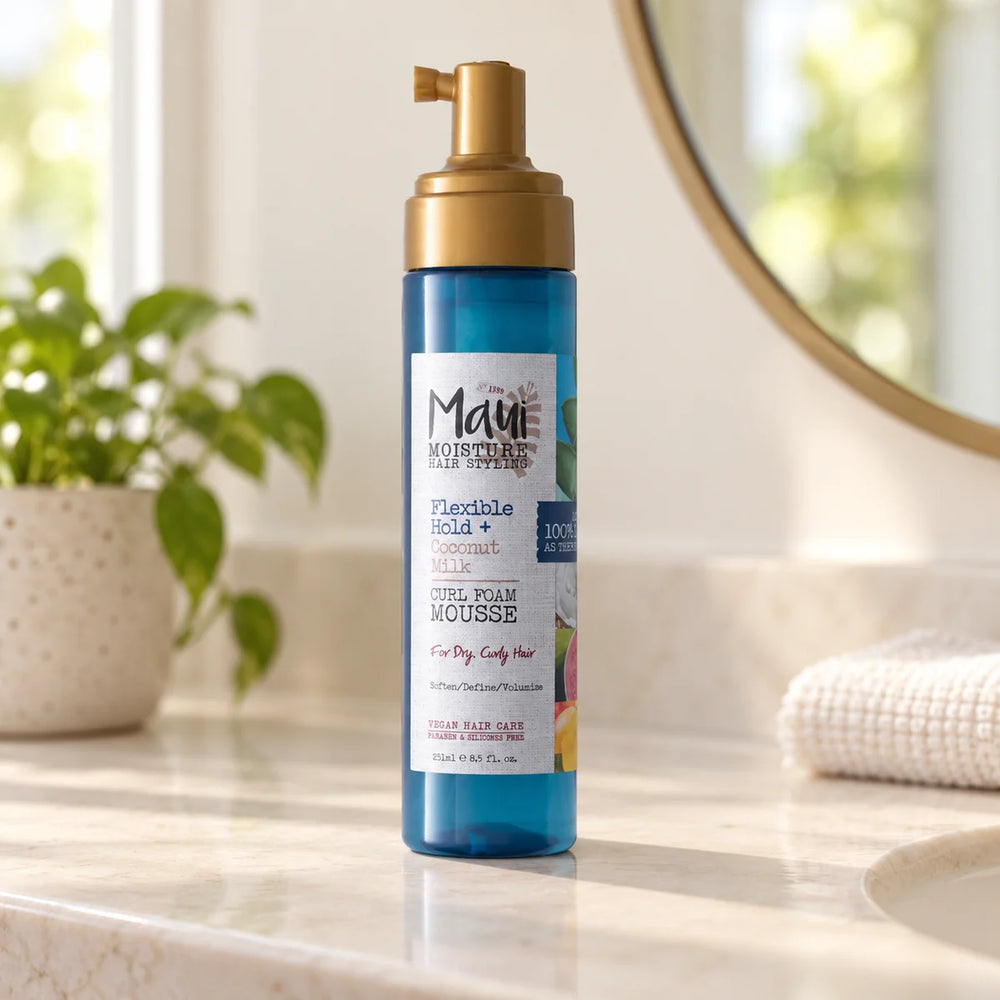 Maui Moisture Flexible Hold + Coconut Milk Curl Foam Mousse Lightweight Definition for Curls — 251 ml on a bathroom vanity.