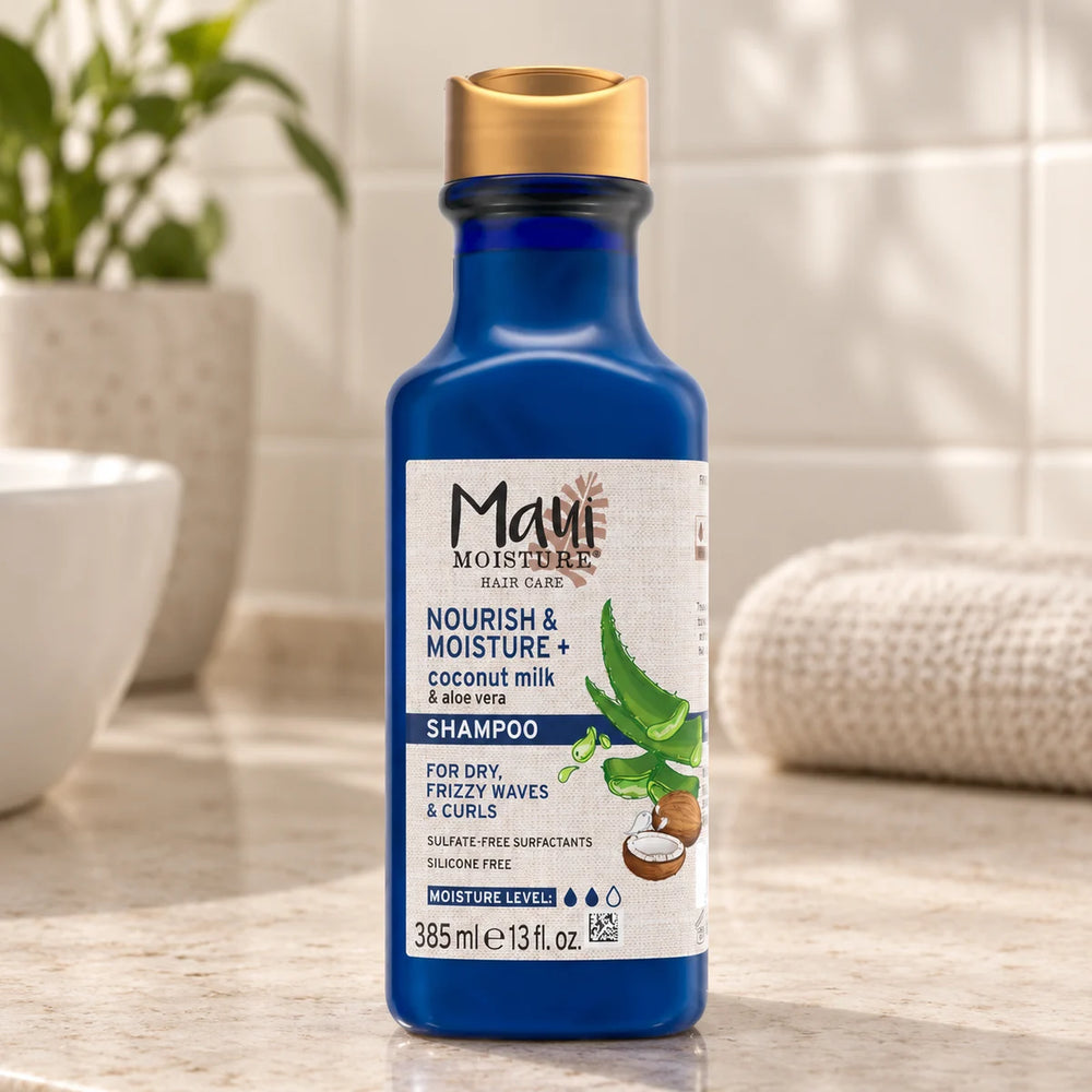 Maui Moisture Nourish & Moisture + Coconut Milk Shampoo — 385 ml on a bathroom vanity.