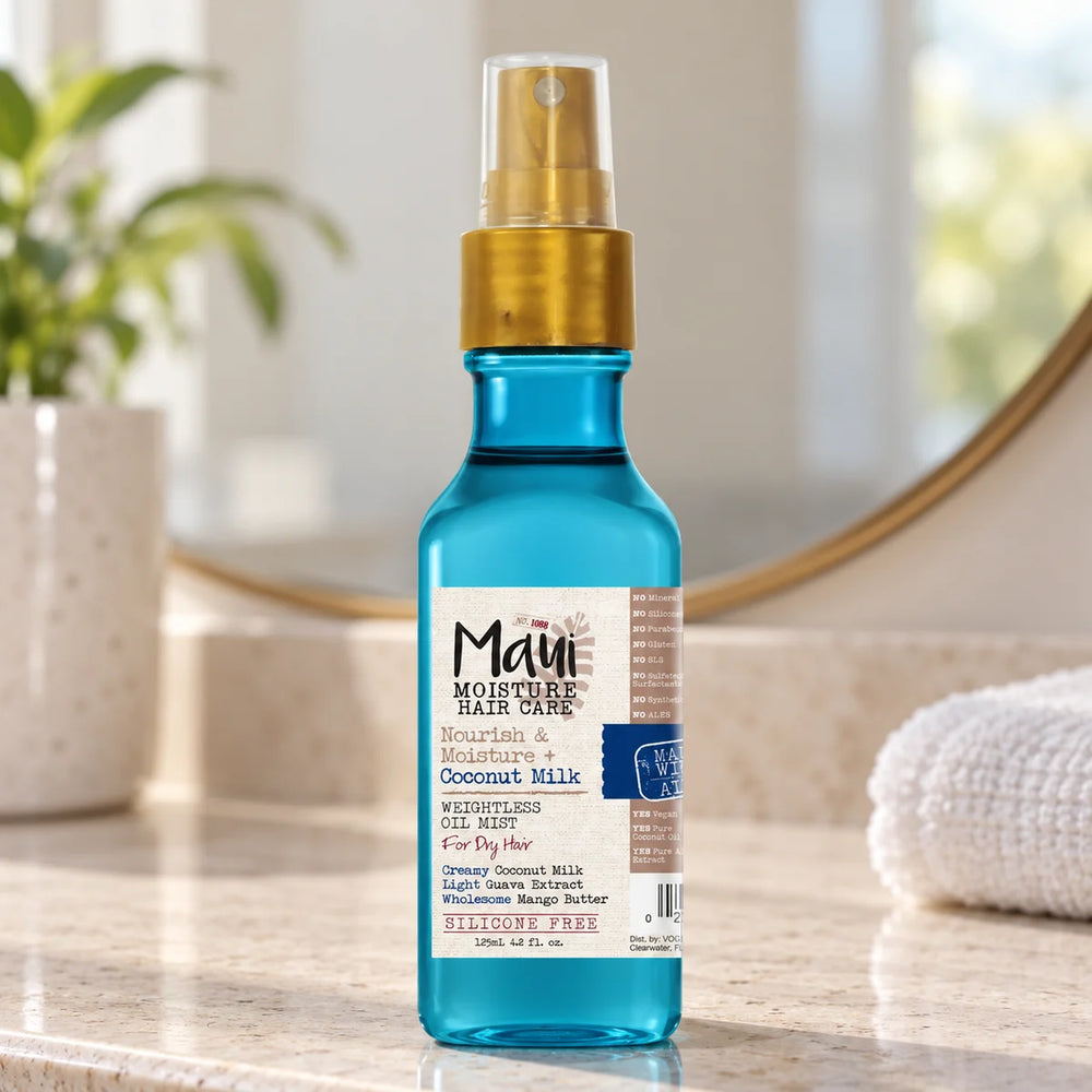 Maui Moisture Nourish & Moisture + Coconut Milk Weightless Oil Mist — 125 ml on a bathroom vanity.