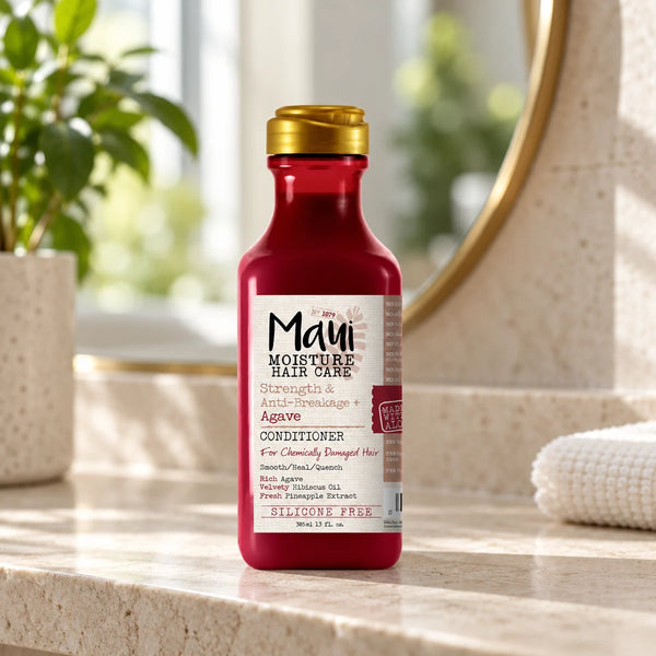 Maui Moisture Strength & Length + Agave Conditioner Detangling Care for Chemically Treated Hair — 385 ml on a bathroom vanity.