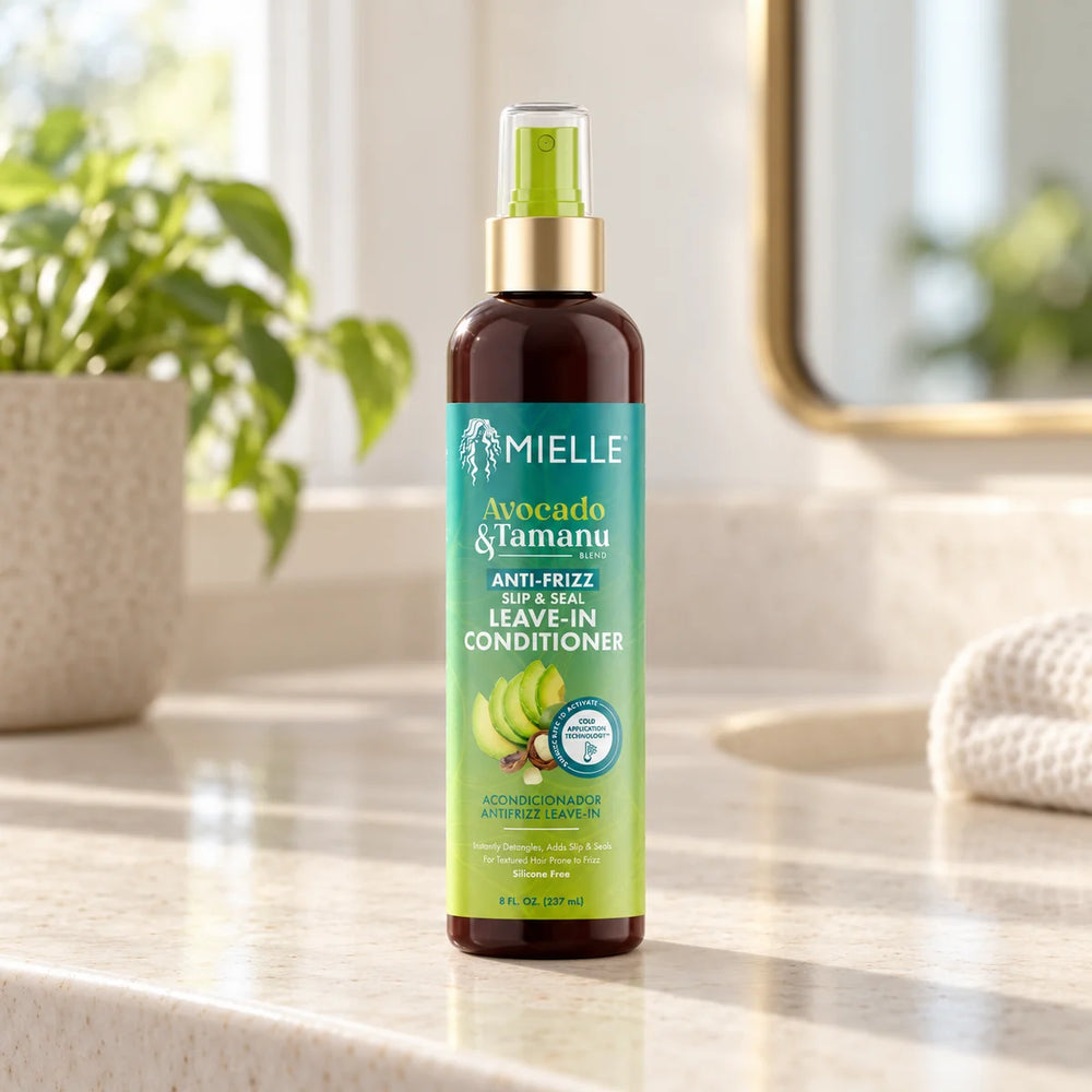 Mielle Avocado & Tamanu Anti-Frizz Slip & Seal Leave-In Conditioner — 8 oz on a bathroom vanity.