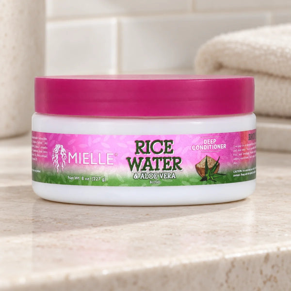 Mielle Rice Water & Aloe Deep Conditioner — 8 oz on a bathroom vanity.