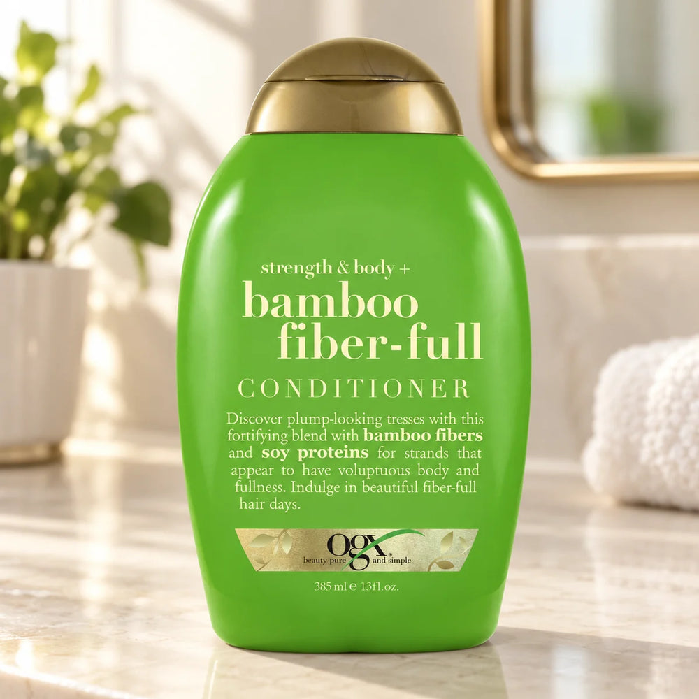OGX Strength & Body+ Bamboo Fiber-Full Conditioner for Volumising & Strengthening Fine, Weak Hair 13 fl oz — 13 fl oz on a bathroom vanity.