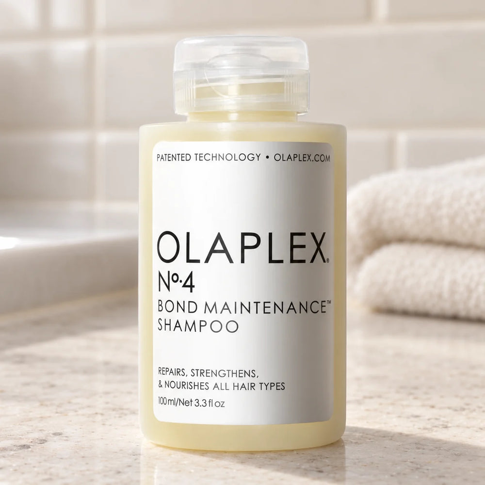 Olaplex No.4 Bond Maintenance Shampoo — 100 ml on a bathroom vanity.