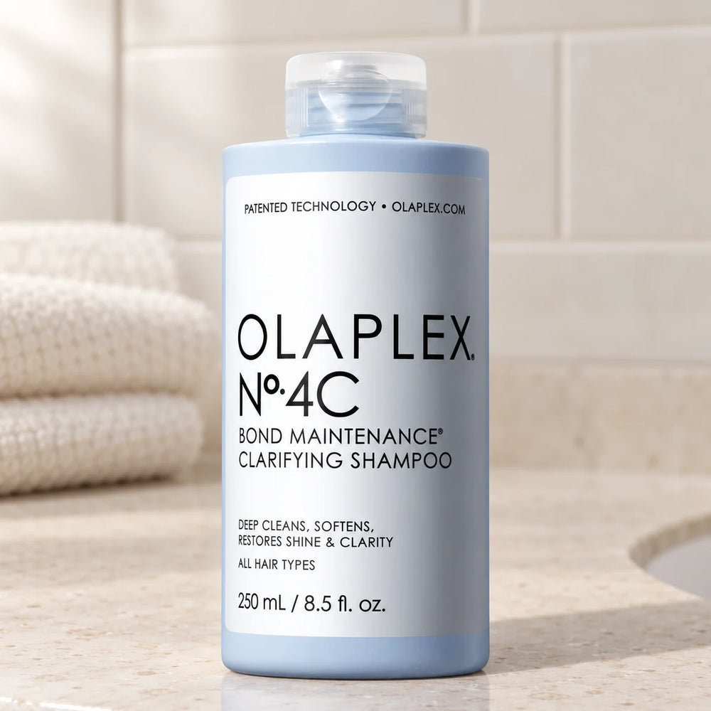 Olaplex No.4C Bond Maintenance Clarifying Shampoo — 8.5 oz on a bathroom vanity.