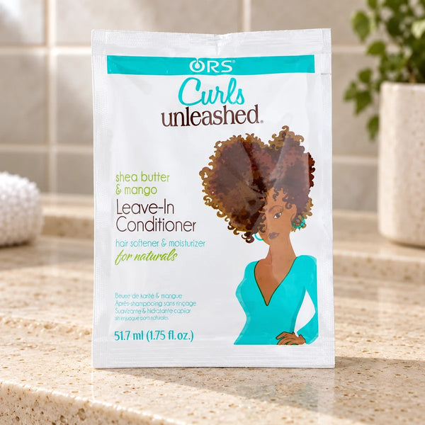 ORS Curls Unleashed Leave-In Conditioner — 1.7 oz on a bathroom vanity.