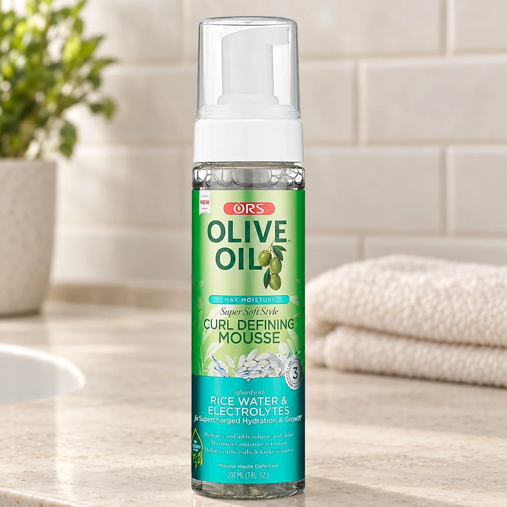 ORS Max Moisture Curl Defining Mousse 7oz for Defined Curls — 7 oz on a bathroom vanity.