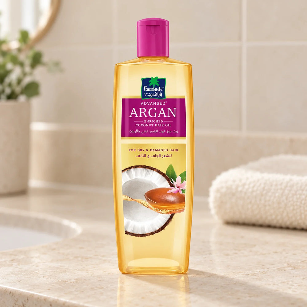 Parachute Advansed Argan-Enriched Coconut Hair Oil — 200 ml on a bathroom vanity.