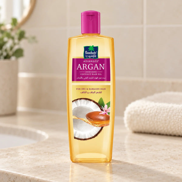 Parachute Advansed Argan-Enriched Coconut Hair Oil — 200 ml on a bathroom vanity.