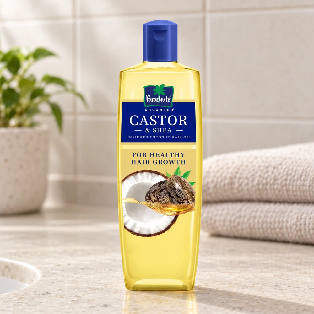 Parachute Advansed Castor & Shea-Enriched Coconut Hair Oil — 200 ml on a bathroom vanity.