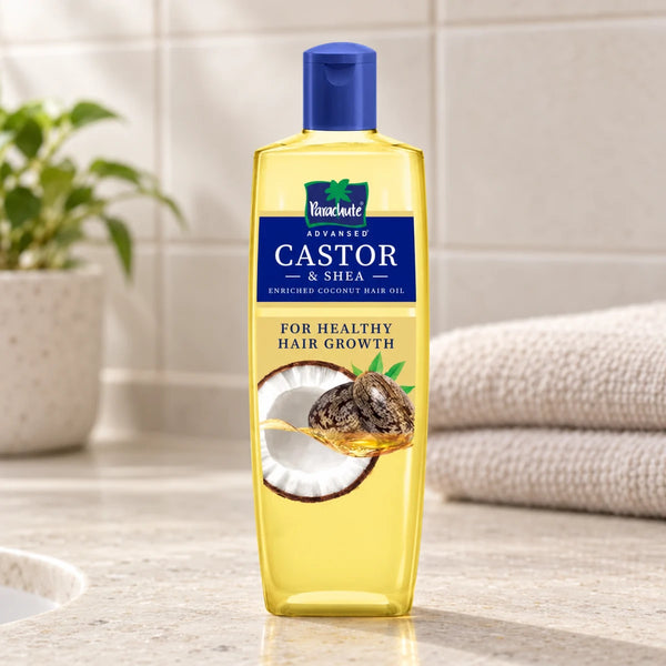 Parachute Advansed Castor & Shea-Enriched Coconut Hair Oil — 200 ml on a bathroom vanity.
