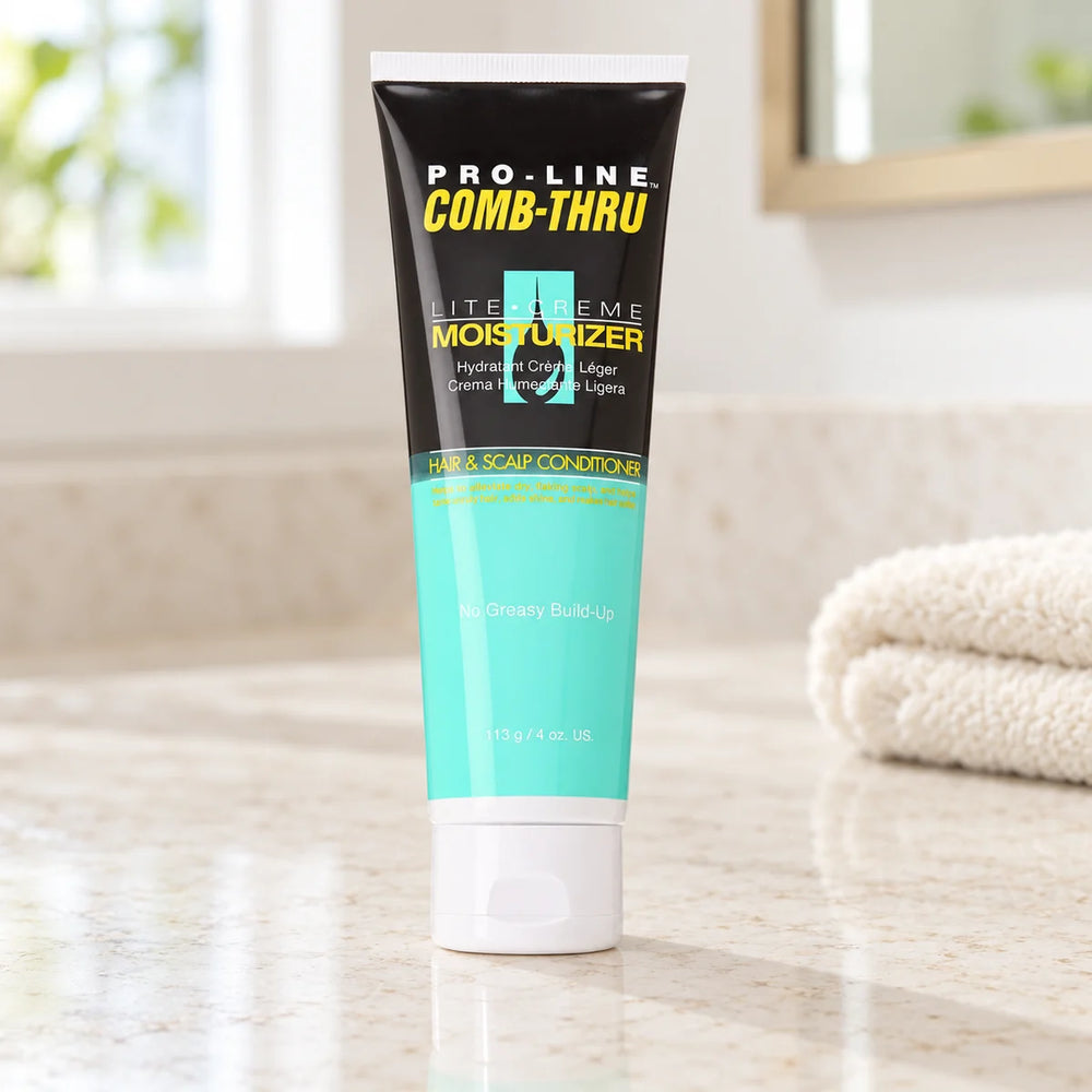 Pro-Line Comb-Thru Lite-Creme Moisturizer: Moisturizing & Detangling for Textured Hair — 113 g on a bathroom vanity or dressing table.