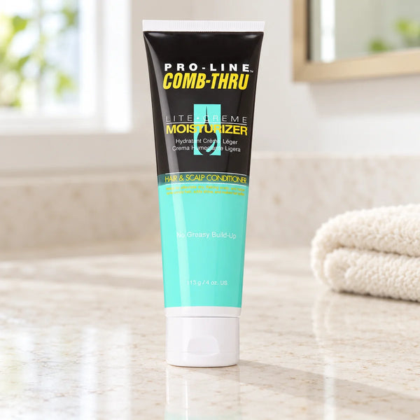 Pro-Line Comb-Thru Lite-Creme Moisturizer: Moisturizing & Detangling for Textured Hair — 113 g on a bathroom vanity or dressing table.