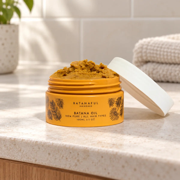 Batanaful 100ml batana oil jar on a bathroom vanity.