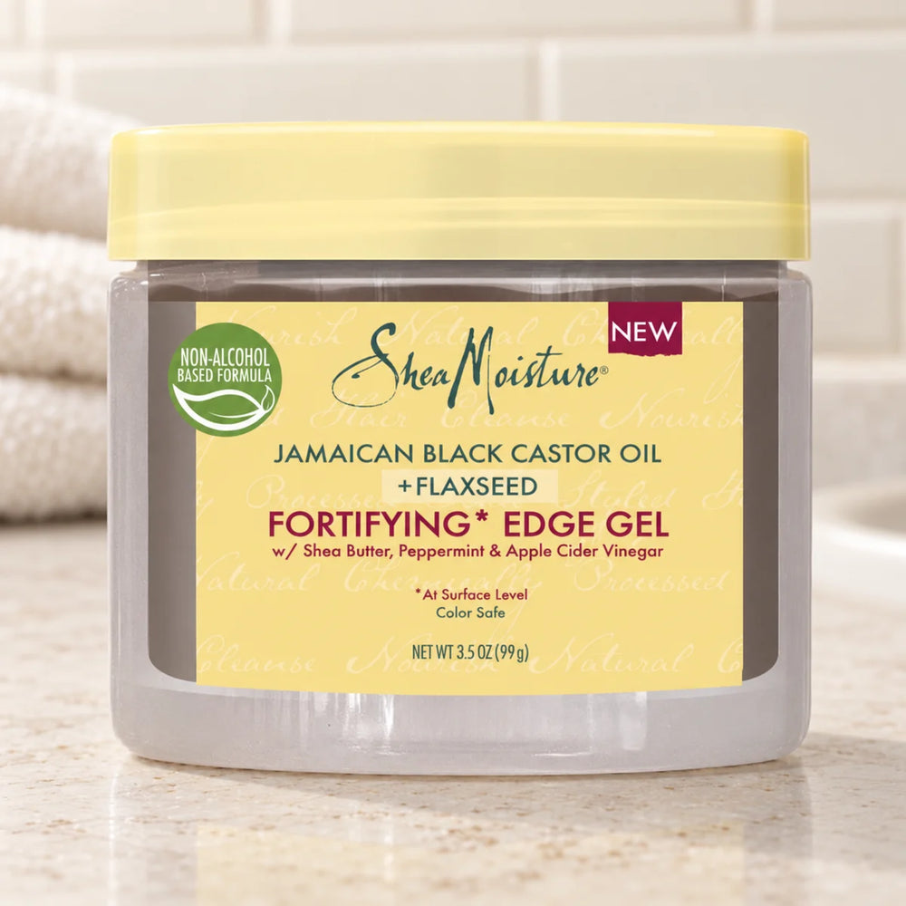 Shea Moisture Jamaican Black Castor Oil Fortifying Edge Gel — 99 g on a bathroom vanity.