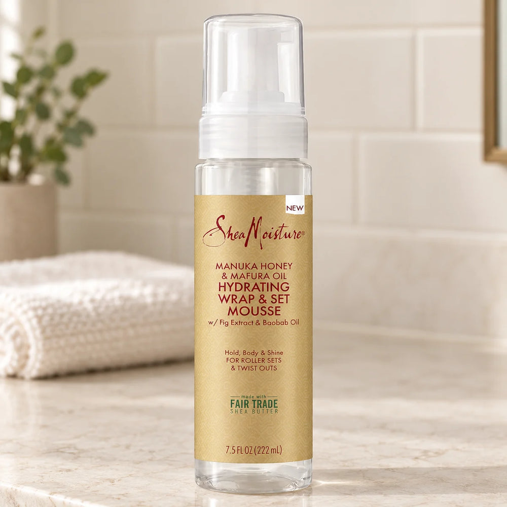 Shea Moisture Manuka Honey & Mafura Oil Hydrating Wrap & Set Mousse — 7.5 oz on a bathroom vanity.