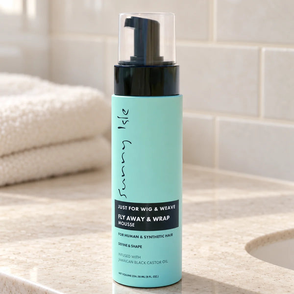 Sunny Isle Just For Wig | Fly Away & Wrap Mousse — 8 oz on a bathroom vanity.