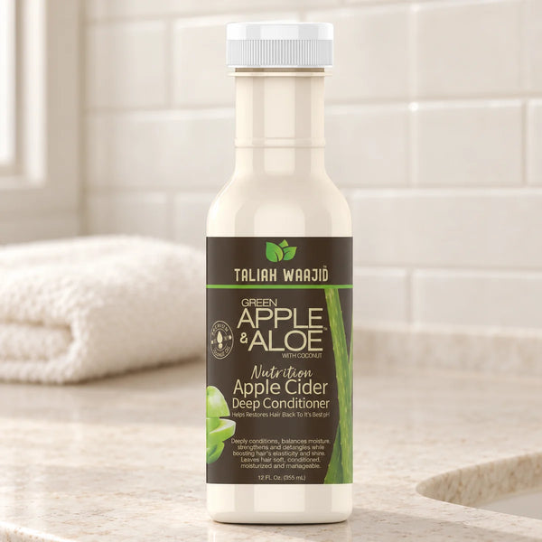 Taliah Waajid Green Apple & Aloe Apple Cider Deep Conditioner Moisture Balance for Dry, Frizzy Hair — 12 oz on a bathroom vanity.
