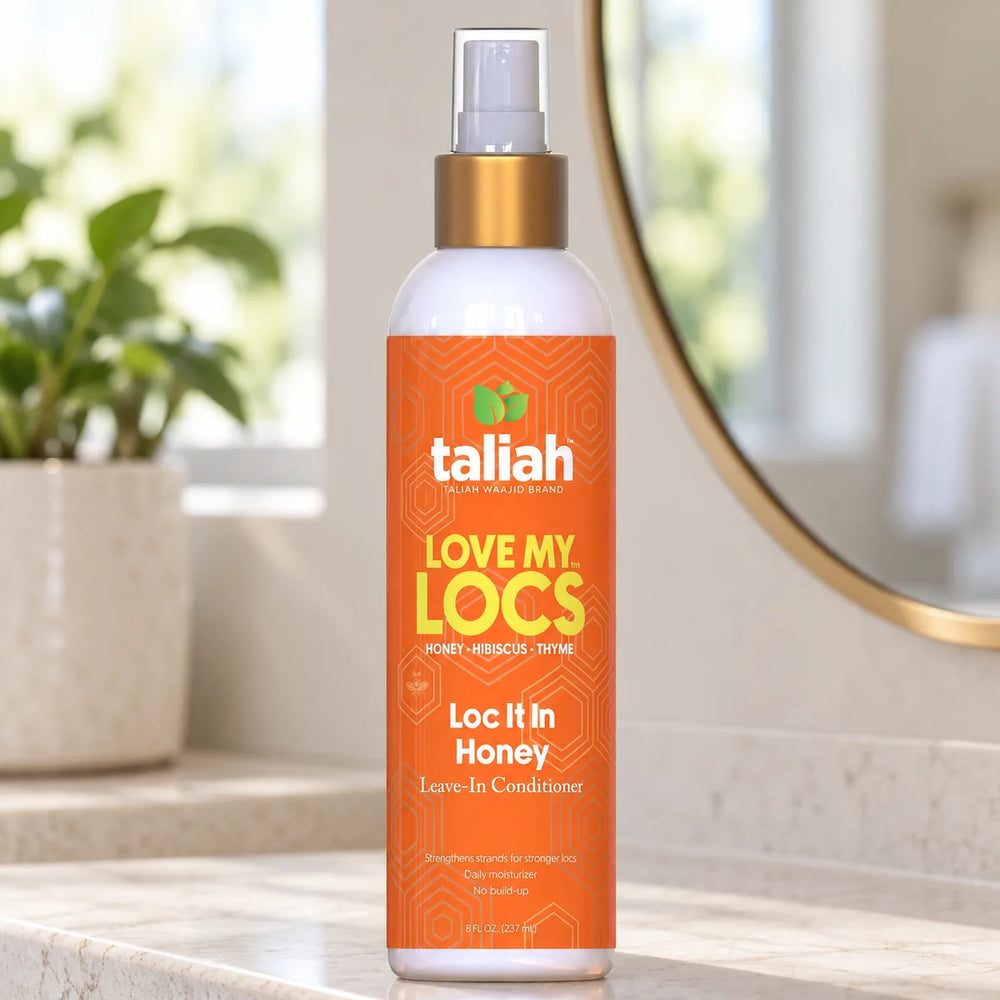 Taliah Waajid Love My Locs Loc It In Honey Leave-In Conditioner Hydrating & Frizz-Control for Locs & Natural Hair — 8 oz on a bathroom vanity.