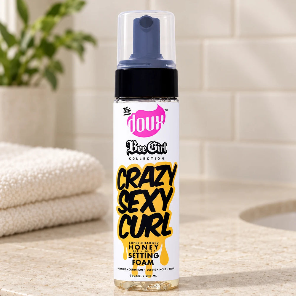 The Doux Crazy Sexy Curl Honey Setting Foam 7oz All-in-1 Styling Mousse — 7 oz on a bathroom vanity.